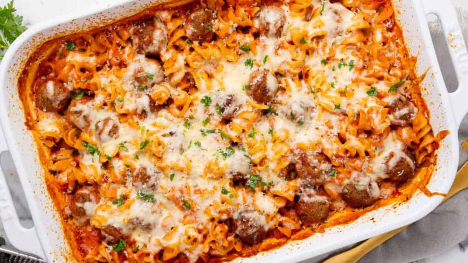 A casserole dish with meatballs and pasta.